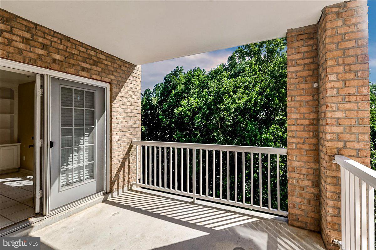 12330 Rosslare Ridge Road, Unit 406 Lutherville-Timonium, MD 21093 - Photo 33 of 37 Sunny balcony with lush greenery view.