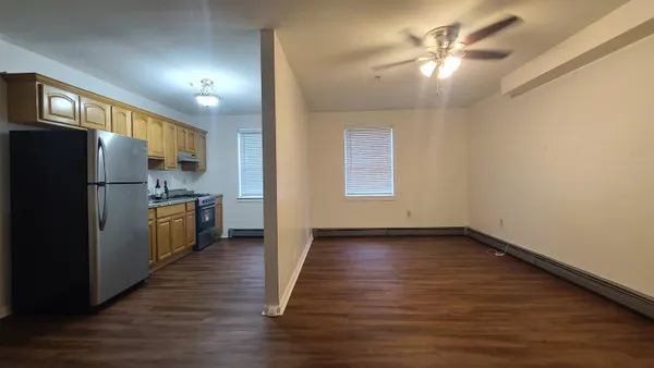 a kitchen with a refrigerator and a chandelier