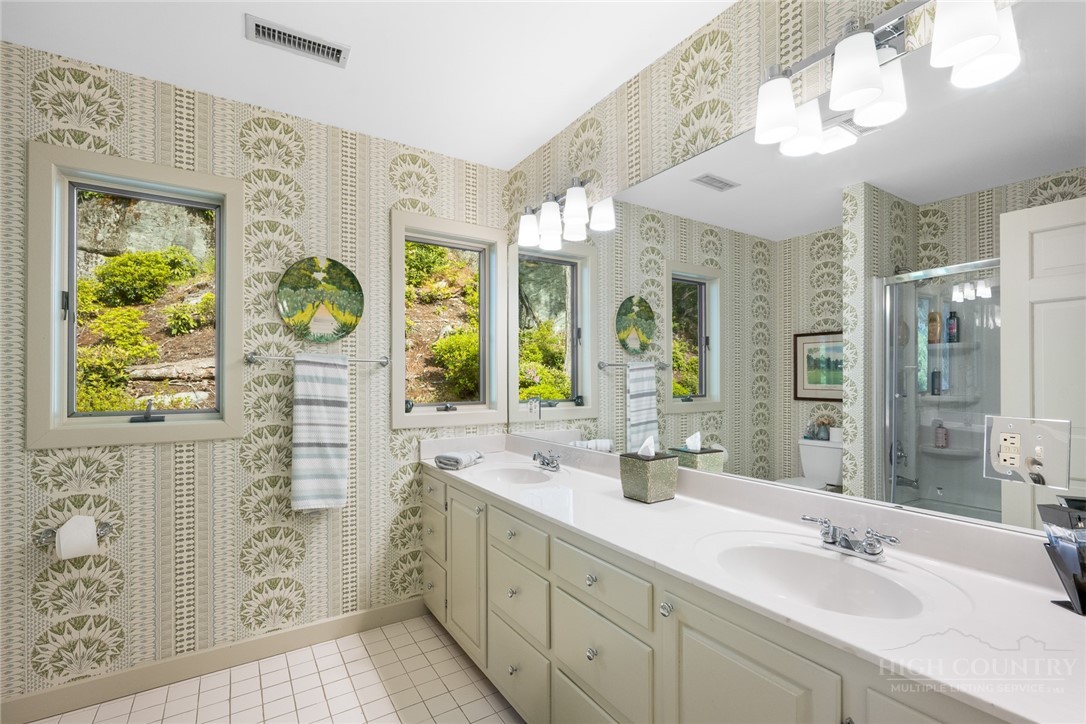 246 Mulberry Lane Boone, NC 28607 - Photo 46 of 49 a bathroom with a double vanity sink mirror and next to a window