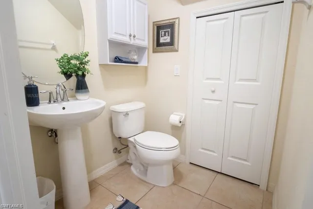 a bathroom with a sink toilet and a mirror