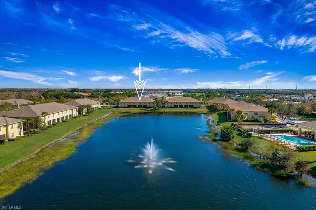 an aerial view of a house with a yard swimming pool outdoor seating