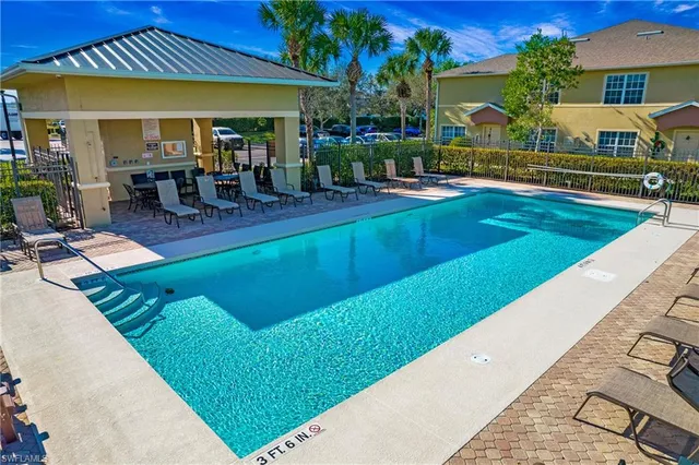 an aerial view of a house with swimming pool garden and patio