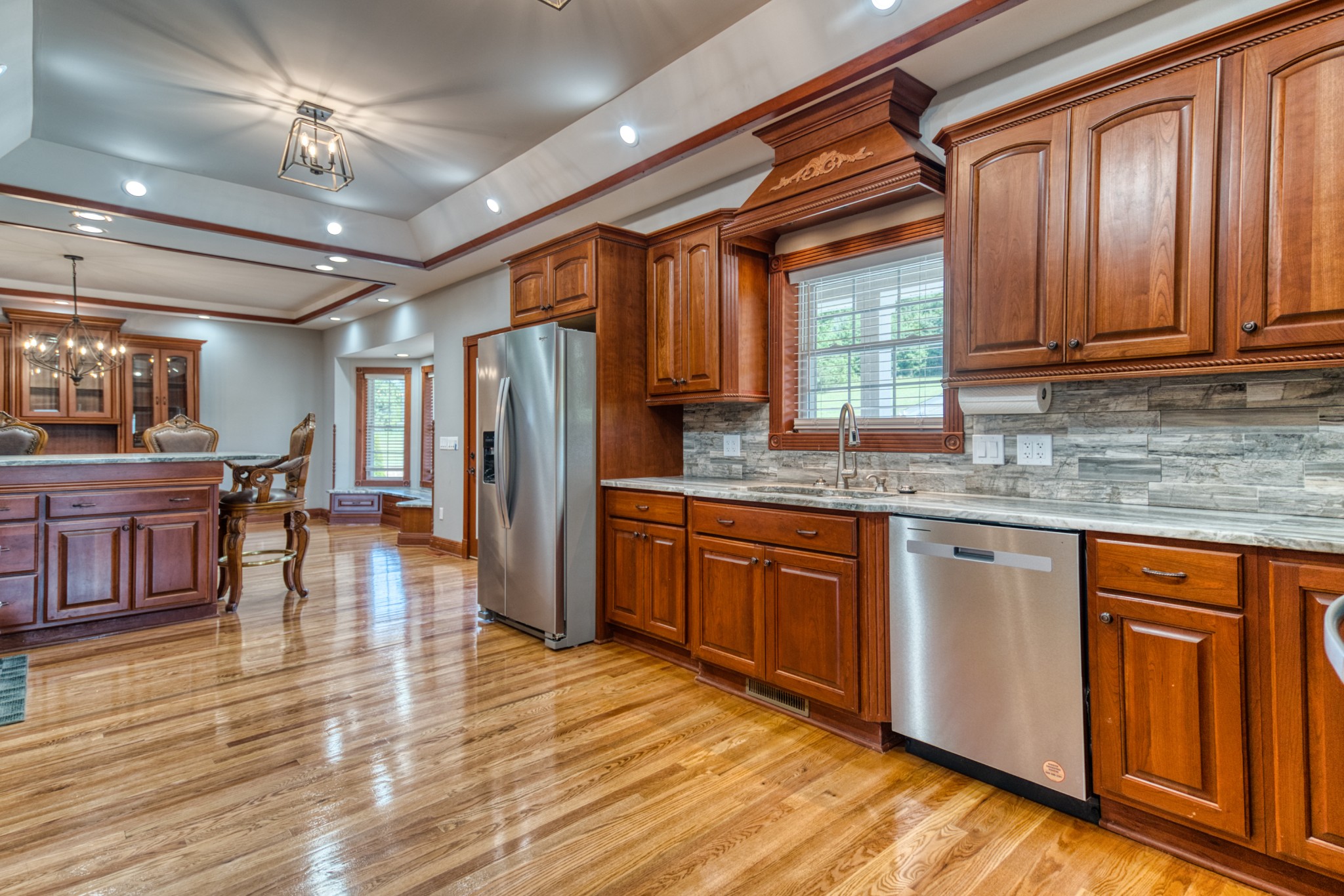 315 Blue And Gray Park Road Elkton, KY 42220 - Photo 33 of 66 a kitchen with stainless steel appliances granite countertop a refrigerator a sink dishwasher a stove and white countertops with wooden floor