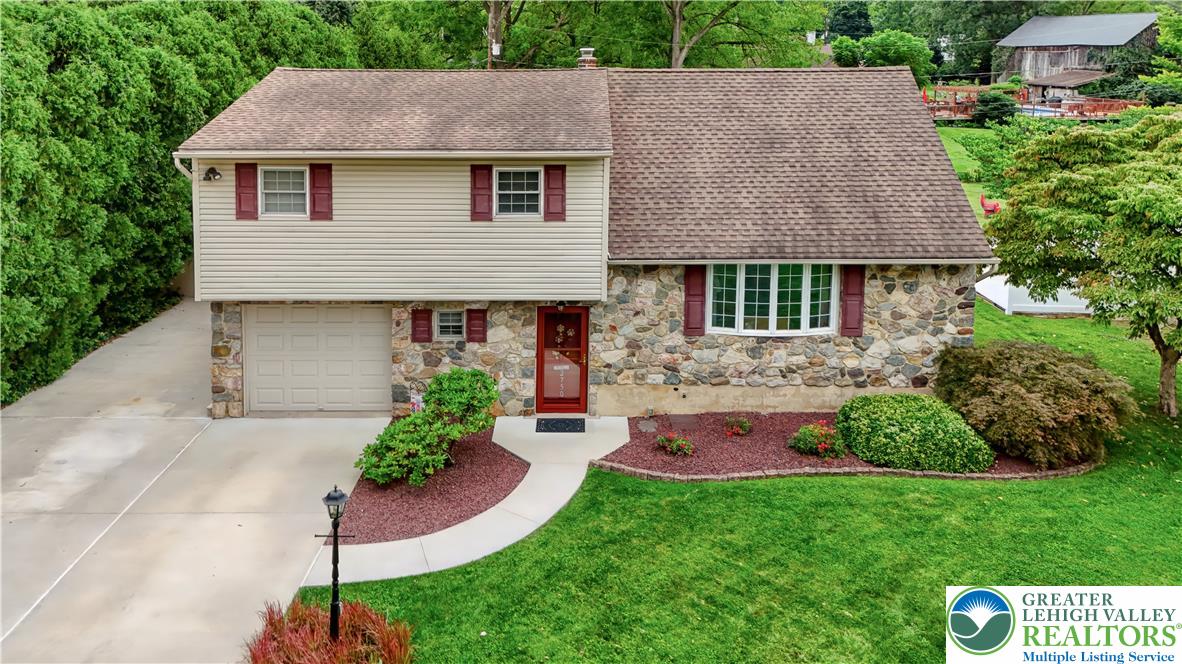 2750 Belaire Road Bethlehem, PA 18017 - Photo 1 of 56 Natural stone and siding define the exterior of this multi-level home with an integrated garage.