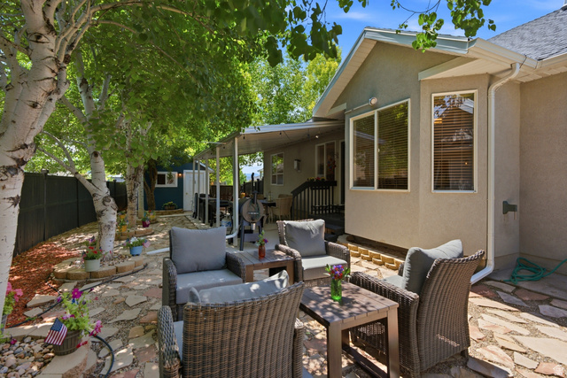 5196 Rodeo Circle Oakley, UT 84055 - Photo 47 of 57 Expansive flagstone patio area with a covered outdoor space and mature trees