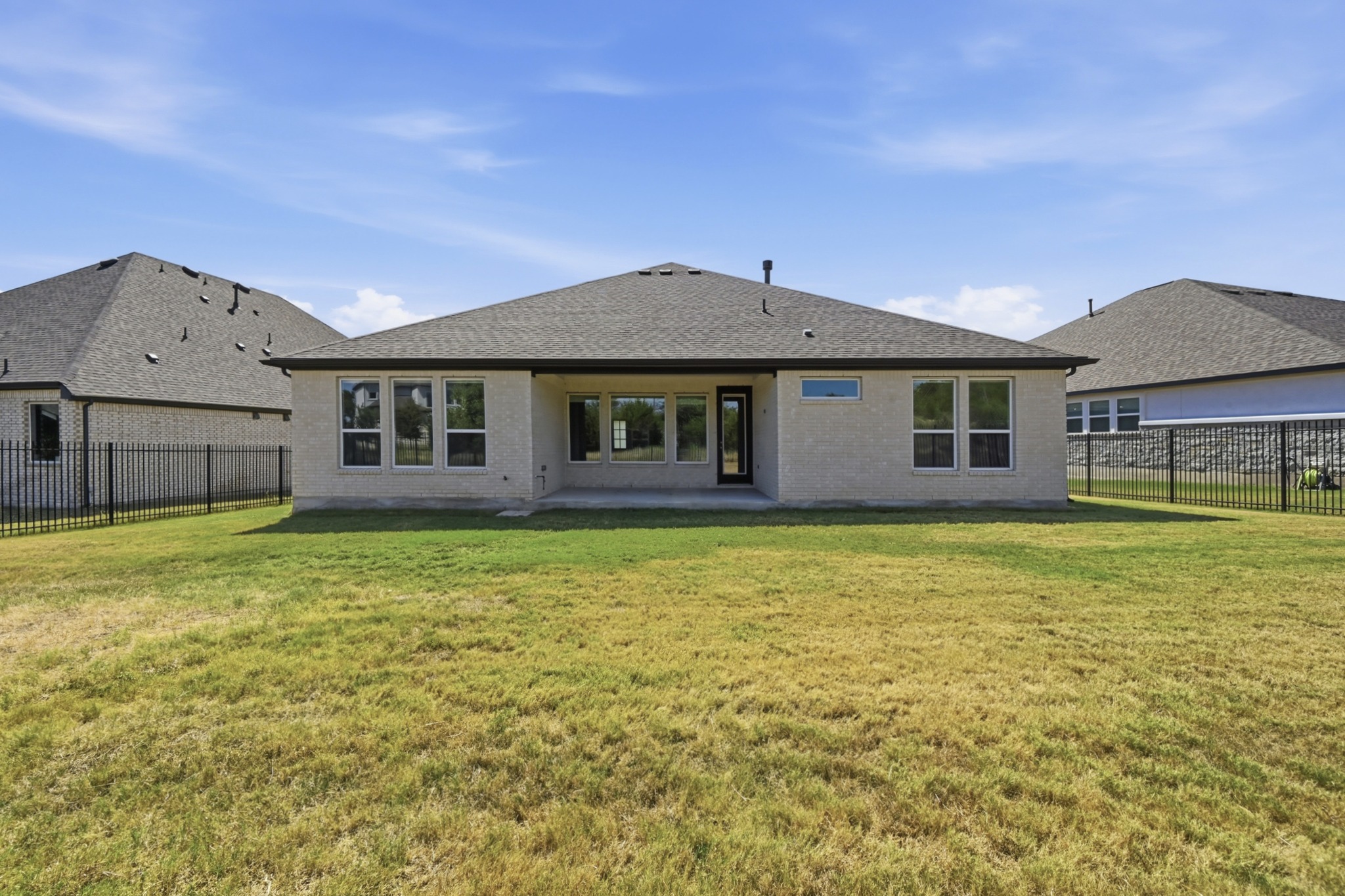 433 Running Bird Road Austin, TX 78737 - Photo 38 of 40 A spacious backyard with an inviting covered patio provides ample outdoor living space.