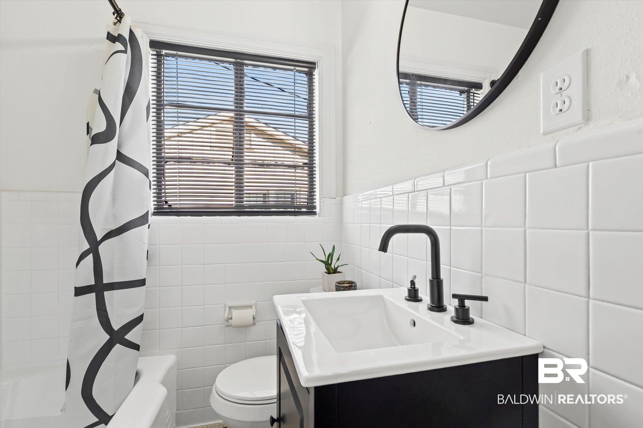 2806 Exter Drive Mobile, AL 36606 - Photo 12 of 24 Bathroom with vanity, tile walls, wainscoting, and shower / bath combo