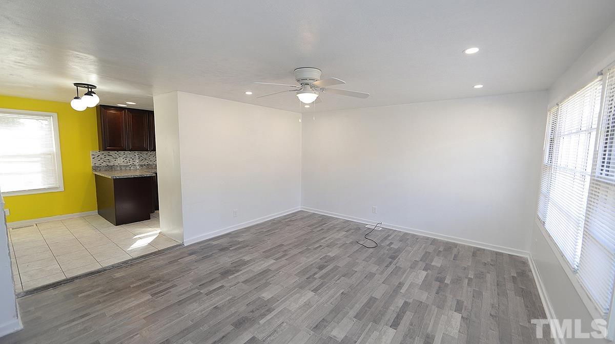 820 Cross Link Road Raleigh, NC 27610 - Photo 2 of 13 wooden floor in an empty room with a window