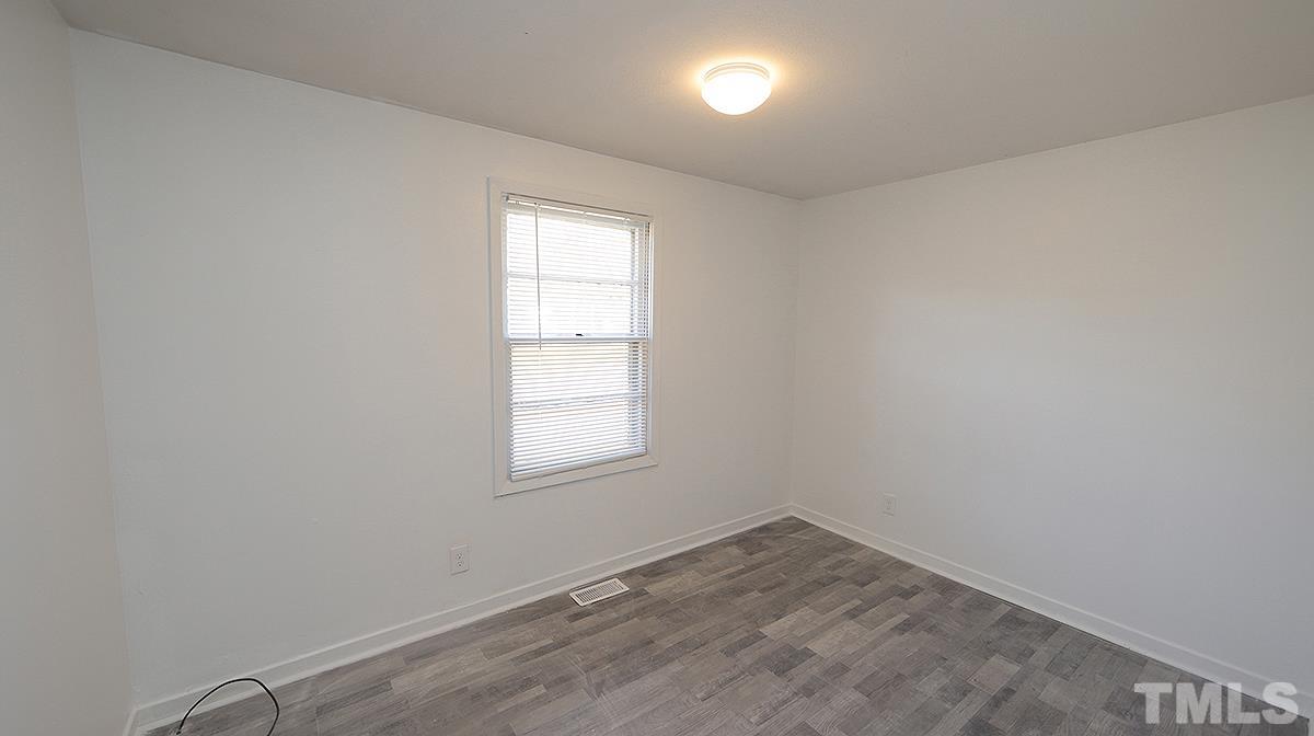 820 Cross Link Road Raleigh, NC 27610 - Photo 11 of 13 an empty room with a window