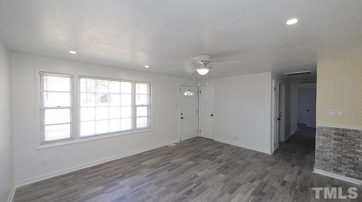 820 Cross Link Road Raleigh, NC 27610 - Photo 3 of 13 an empty room with wooden floor and windows