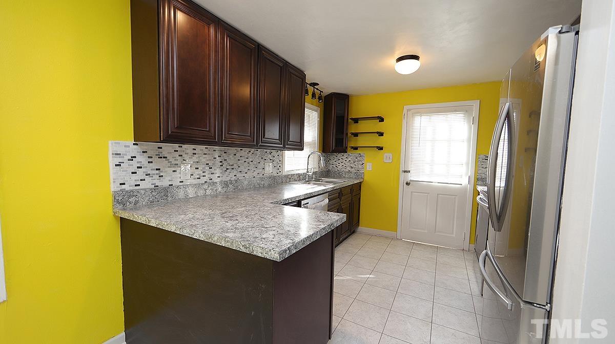 820 Cross Link Road Raleigh, NC 27610 - Photo 5 of 13 a kitchen with a sink refrigerator and cabinets