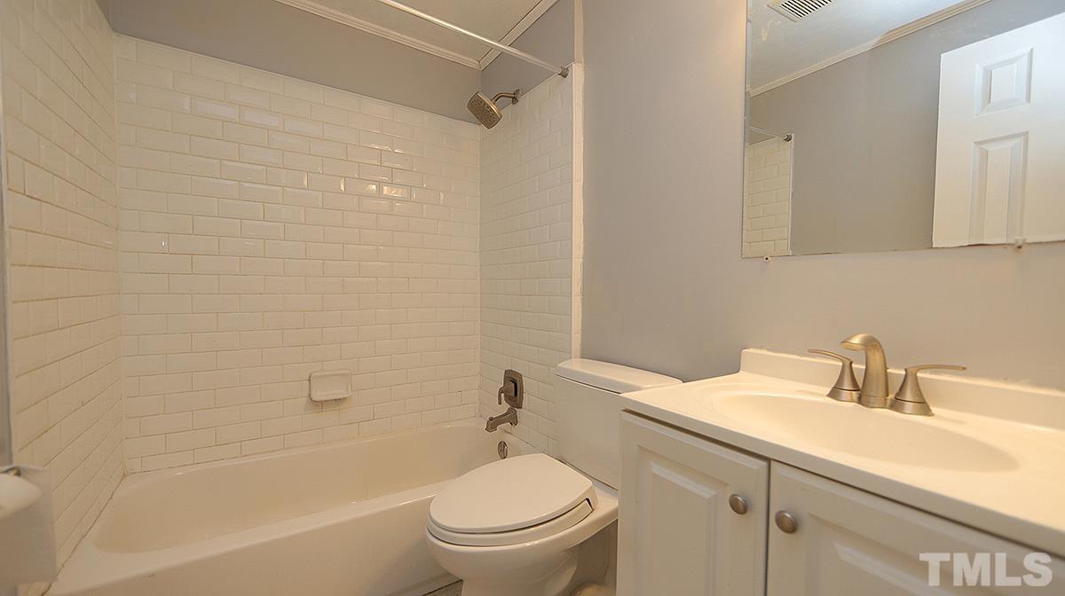 820 Cross Link Road Raleigh, NC 27610 - Photo 10 of 13 a bathroom with a sink toilet and shower