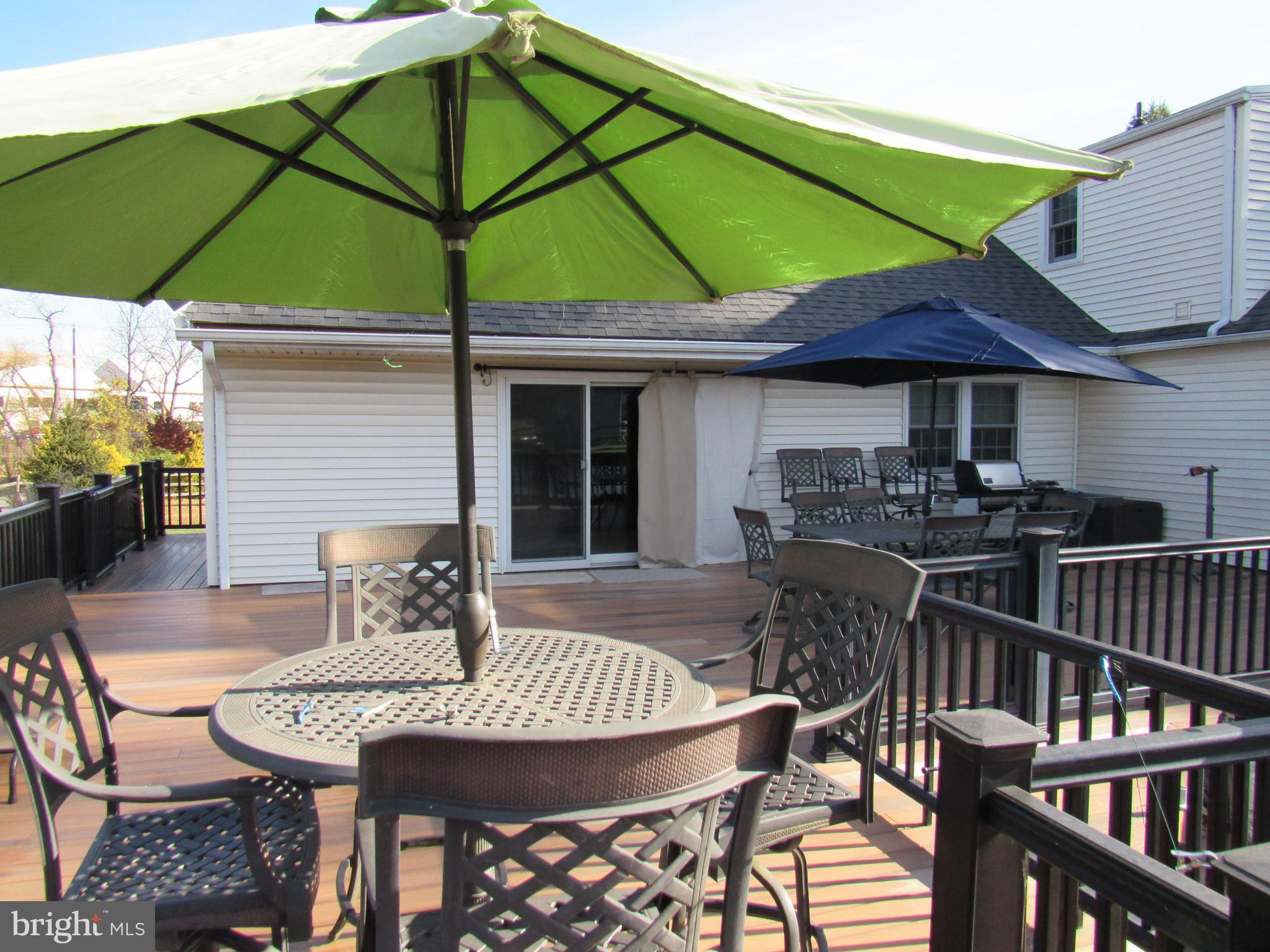 48 Ridge Road Phoenixville, PA 19460 - Photo 18 of 54 a view of a patio with table and chairs under an umbrella