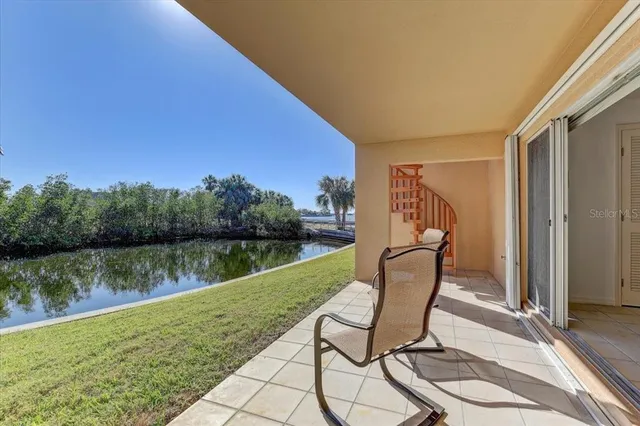 a view of a swimming pool with chair and table in front of house