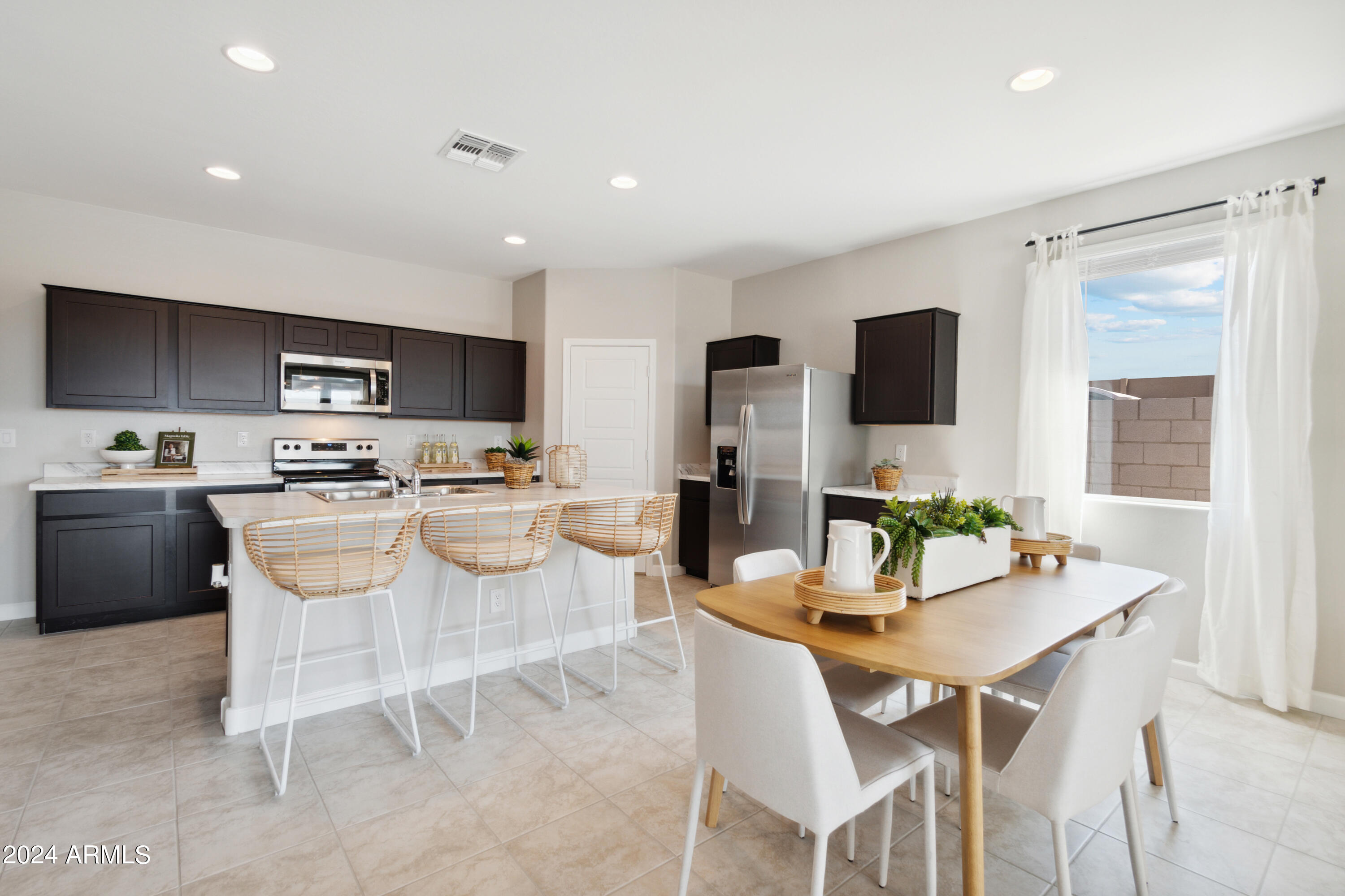 1409 East Bealey Avenue Coolidge, AZ 85128 - Photo 12 of 32 a kitchen with a sink a counter top space and stainless steel appliances