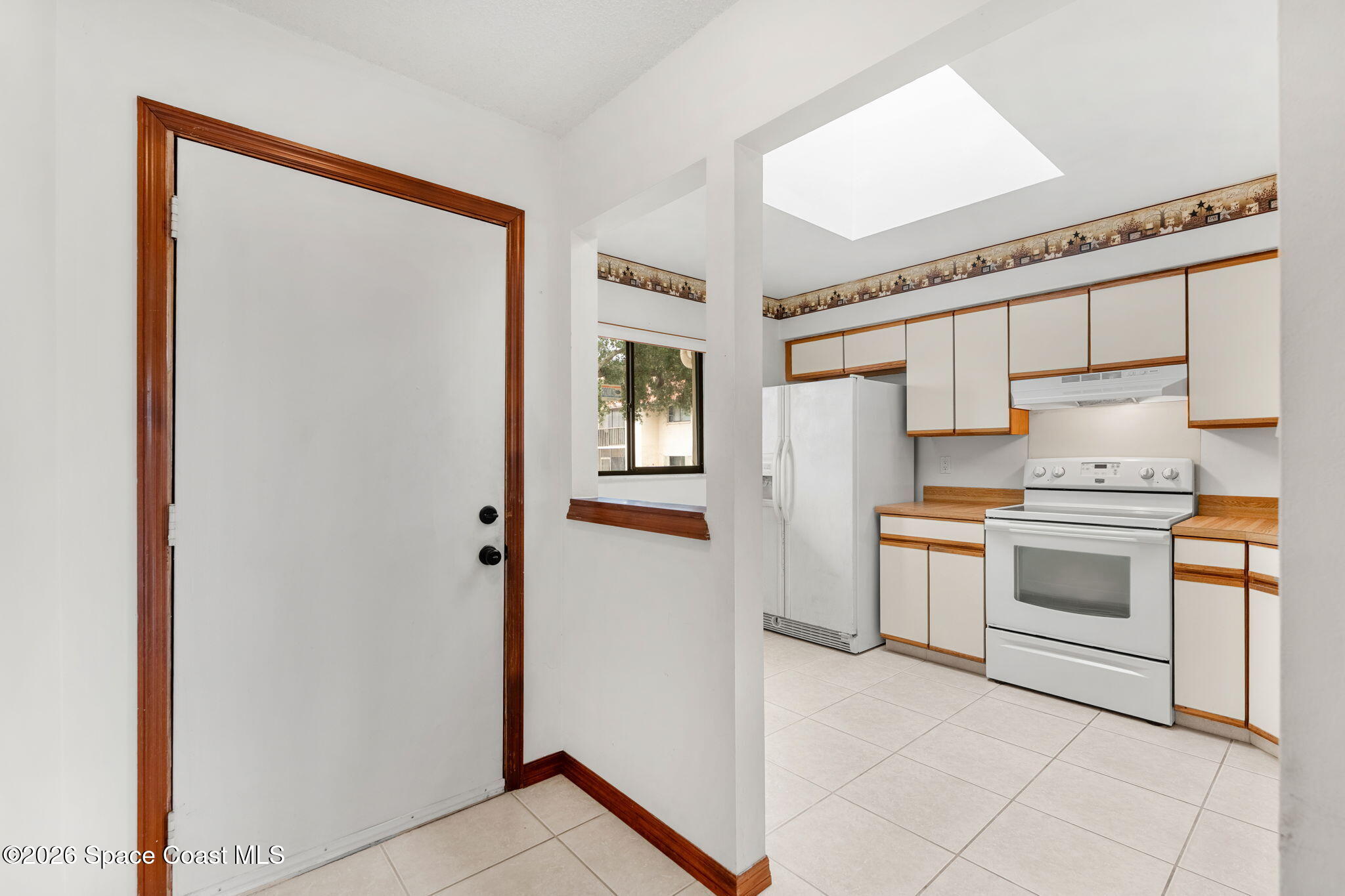 3121 Kirkland Road Northeast Palm Bay, FL 32905 - Photo 7 of 52 a kitchen with stainless steel appliances a refrigerator sink and stove