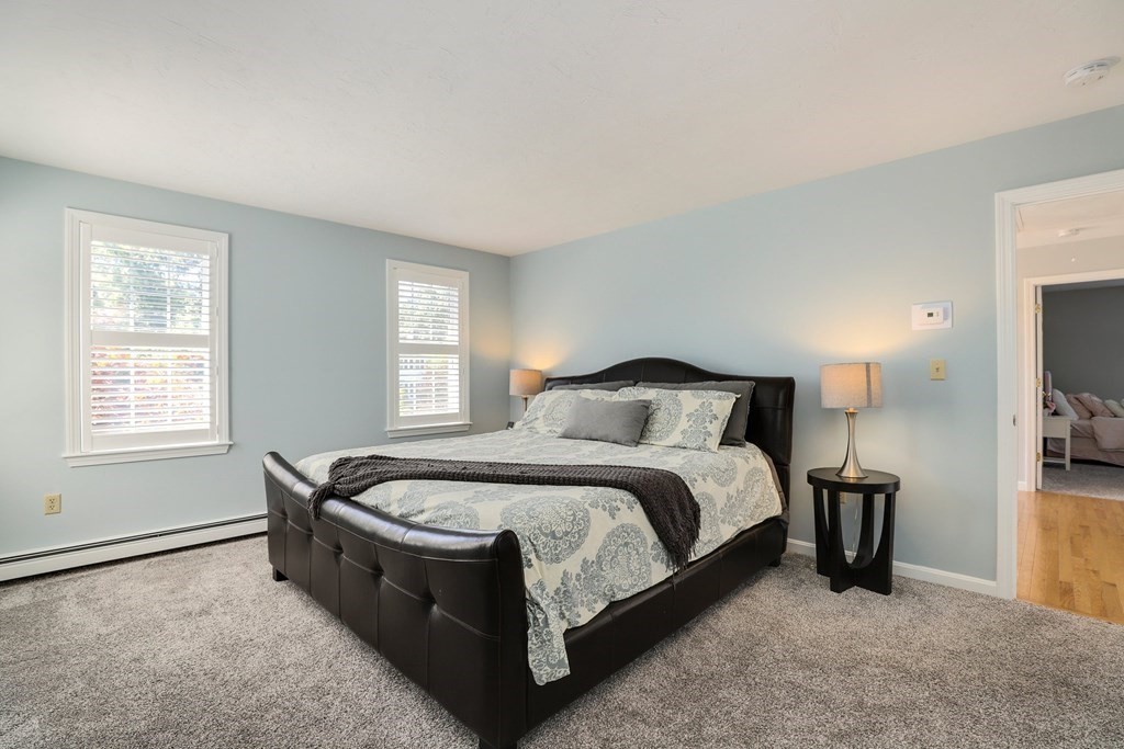 16 Oakbluff Road Sagamore Beach, MA 02562 - Photo 12 of 34 a spacious bedroom with a bed and a flat tv screen on a dresser
