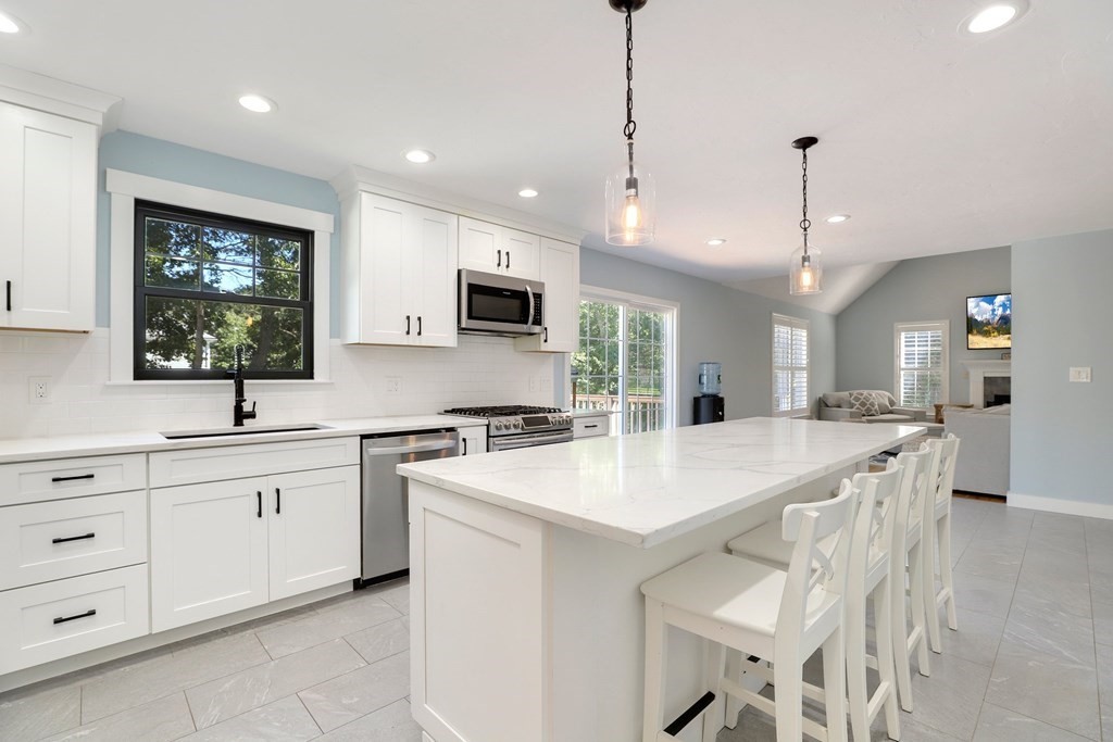 16 Oakbluff Road Sagamore Beach, MA 02562 - Photo 2 of 34 a large kitchen with kitchen island a sink appliances and a counter top space