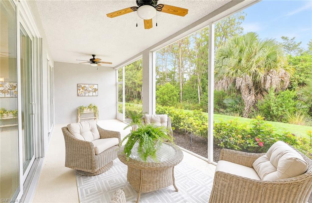2620 Seychelles Circle, Unit 1302 Naples, FL 34112 - Photo 13 of 43 a living room with patio furniture and a floor to ceiling window