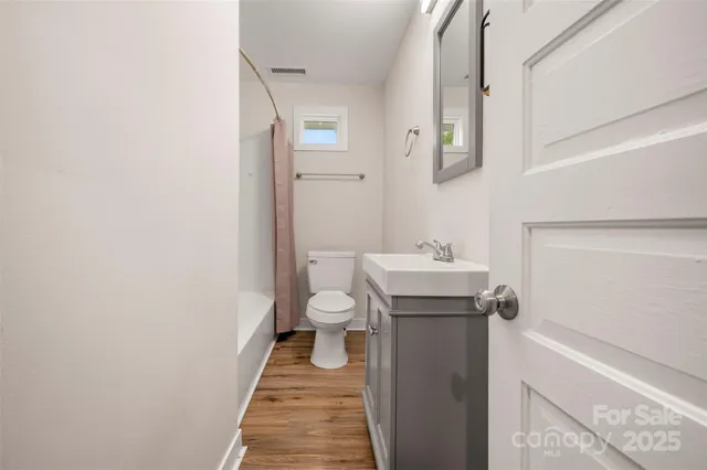 a bathroom with a sink a toilet and mirror