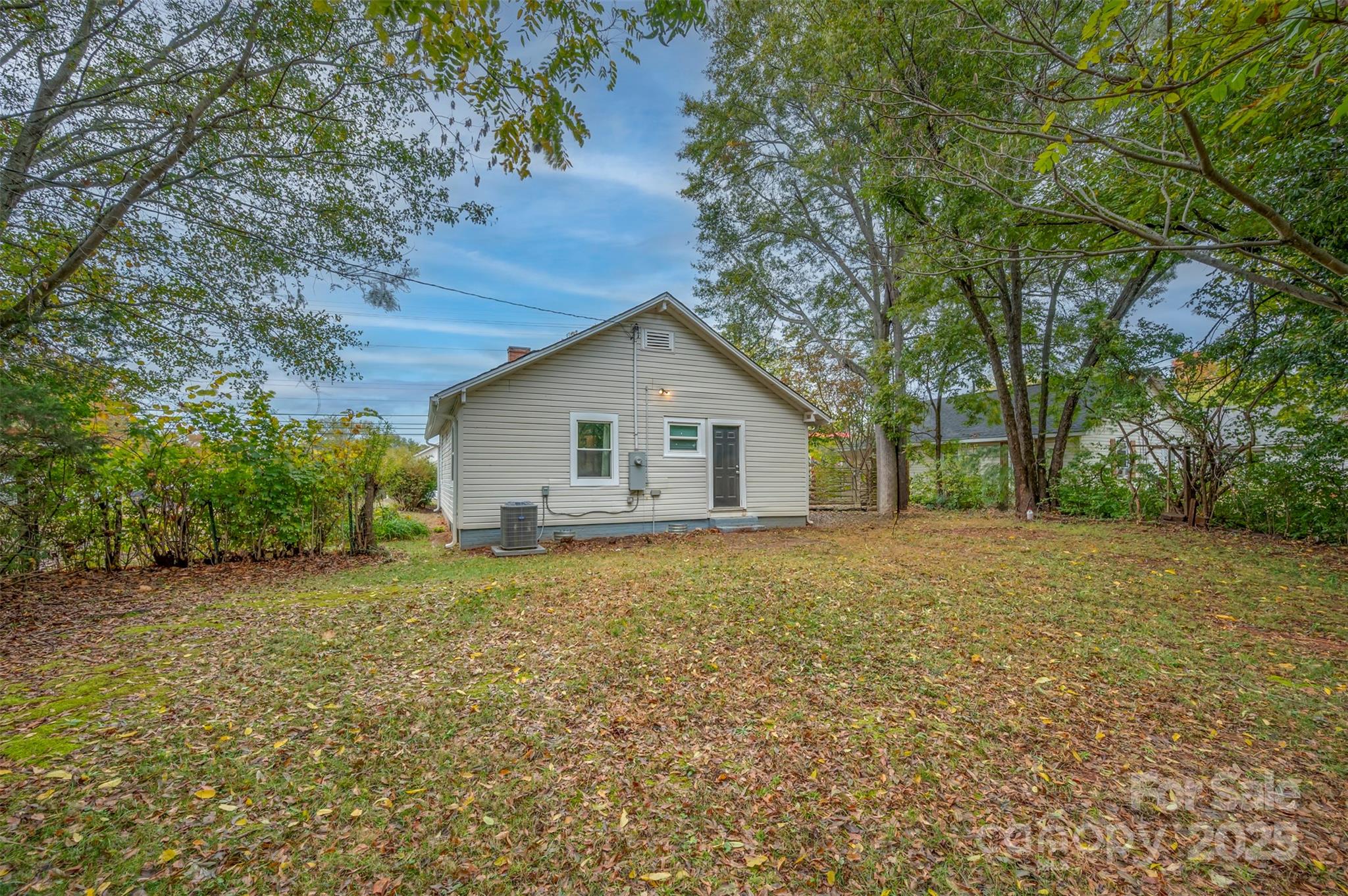 512 Spindale Street Spindale, NC 28160 - Photo 2 of 25 a view of a house with a yard and large trees