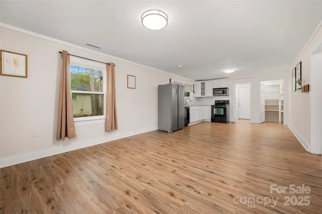 a view of a kitchen with a stove cabinets and wooden floor
