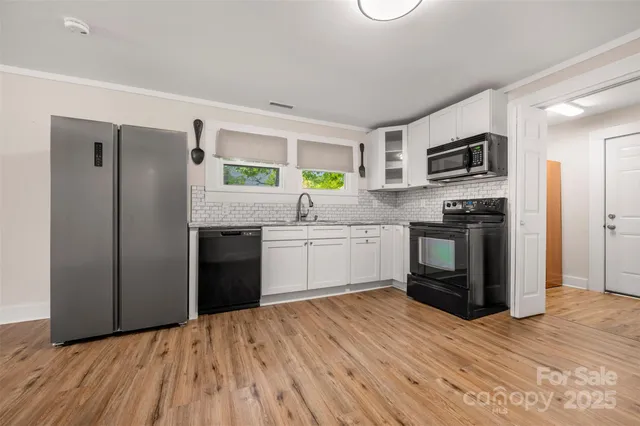 a kitchen with stainless steel appliances a refrigerator sink and stove
