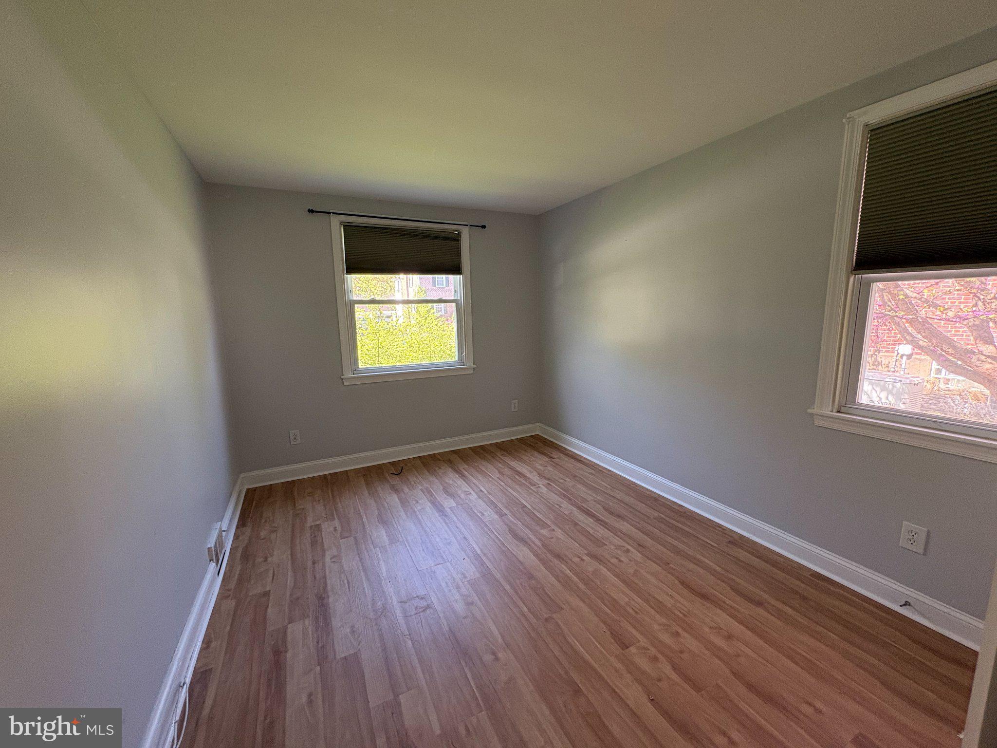 2515 Woodleigh Road Havertown, PA 19083 - Photo 13 of 31 an empty room with wooden floor and windows