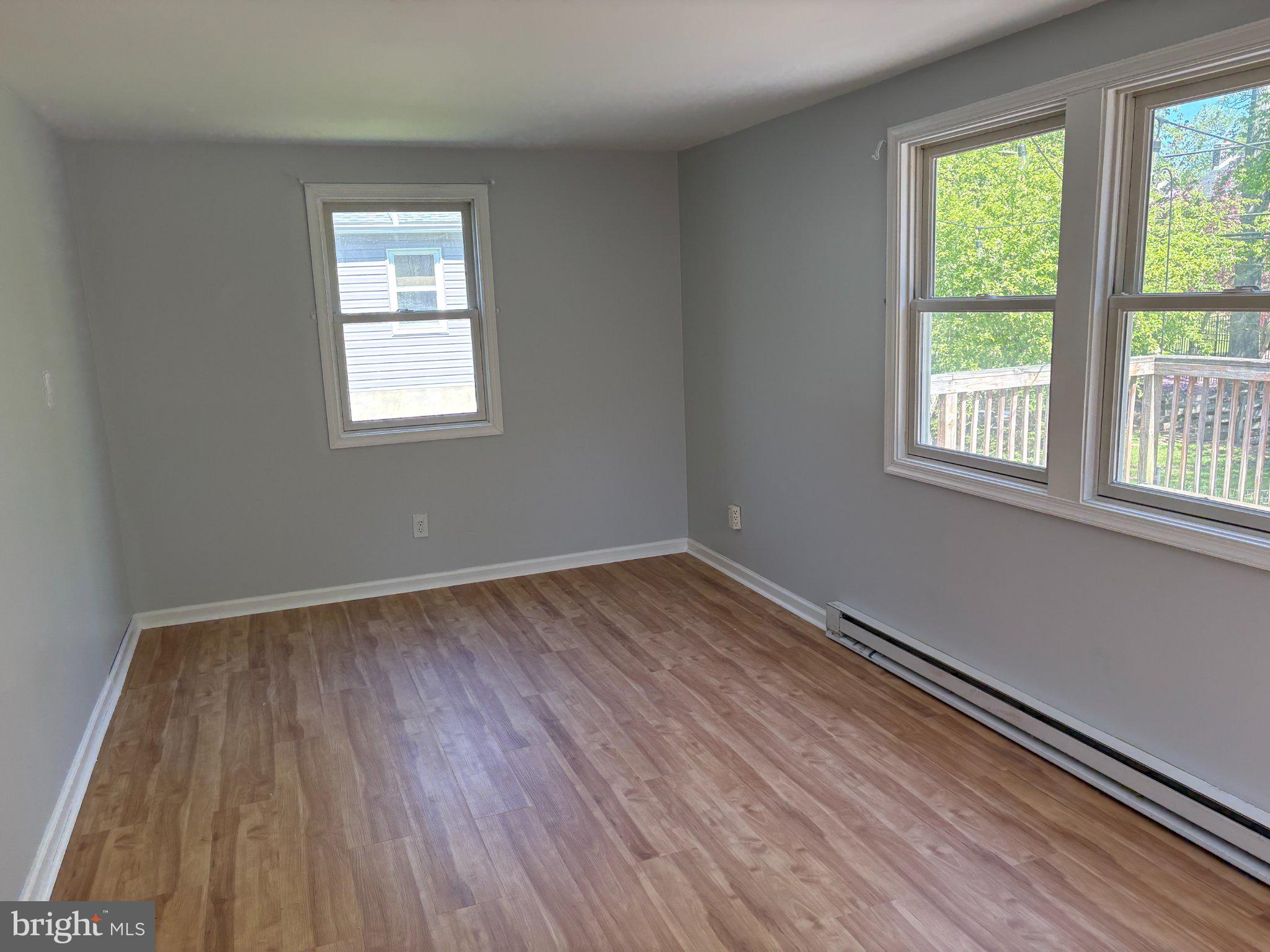2515 Woodleigh Road Havertown, PA 19083 - Photo 14 of 31 an empty room with wooden floor and windows