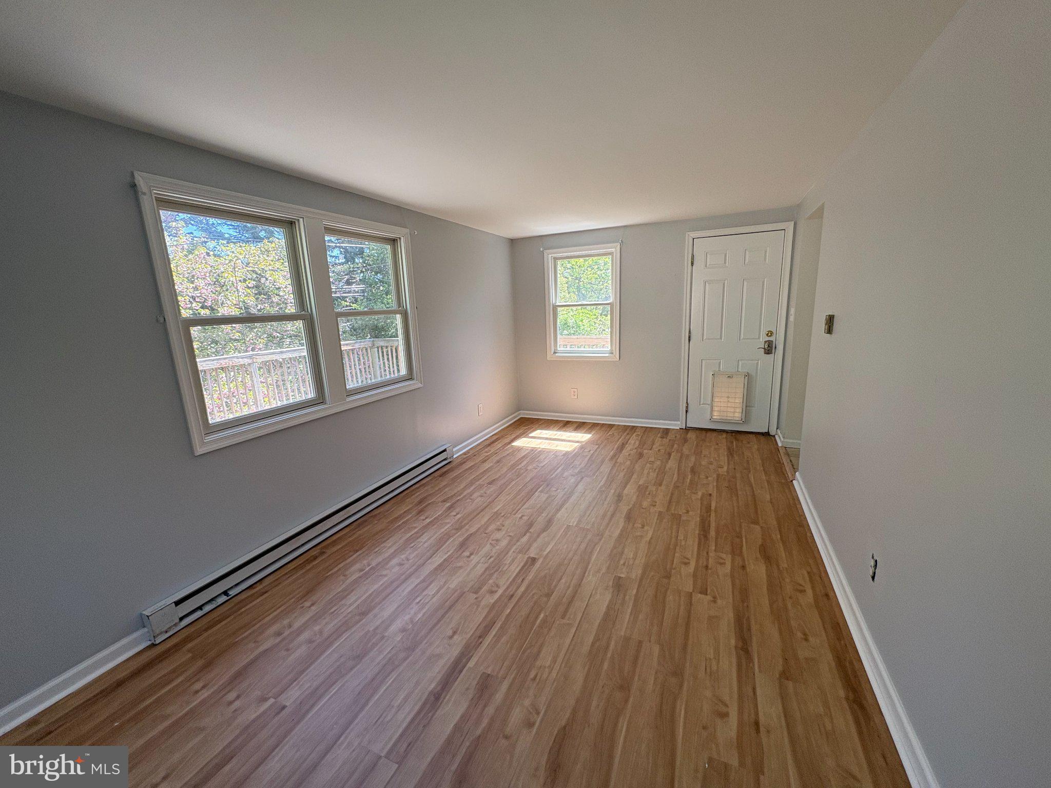 2515 Woodleigh Road Havertown, PA 19083 - Photo 16 of 31 a view of wooden floor in an empty room with a window