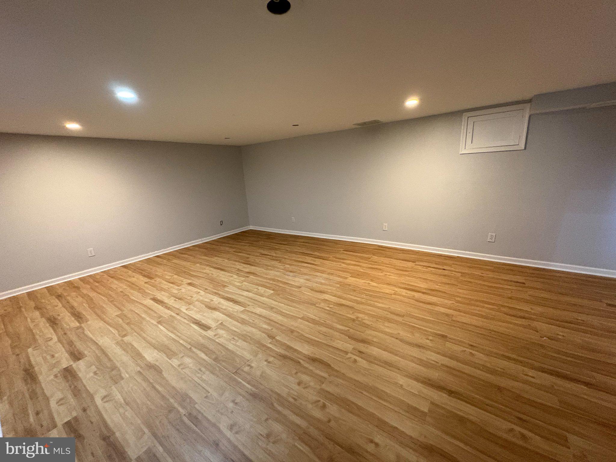 2515 Woodleigh Road Havertown, PA 19083 - Photo 24 of 31 an empty room with wooden floor and windows