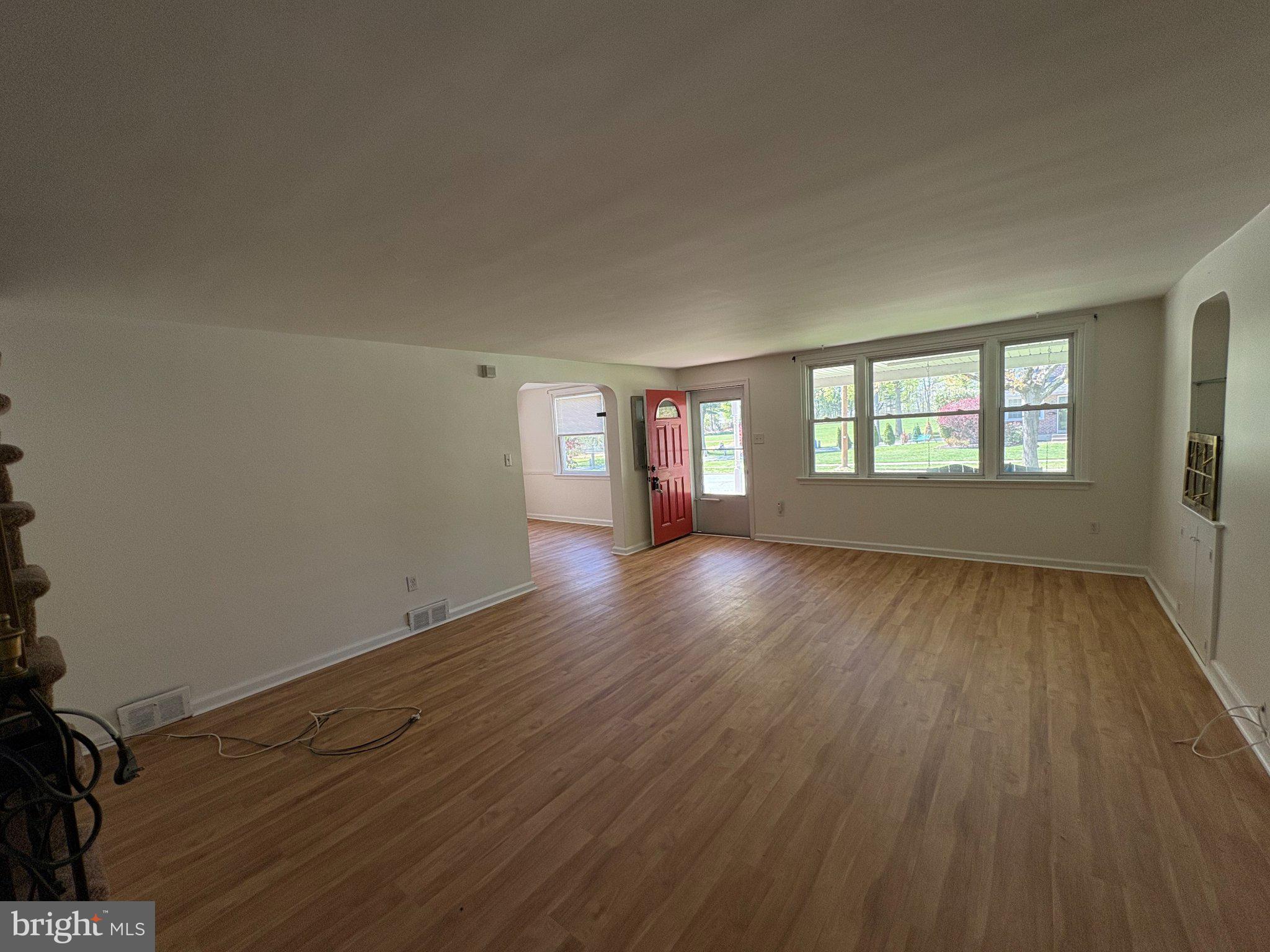 2515 Woodleigh Road Havertown, PA 19083 - Photo 5 of 31 an empty room with wooden floor and windows