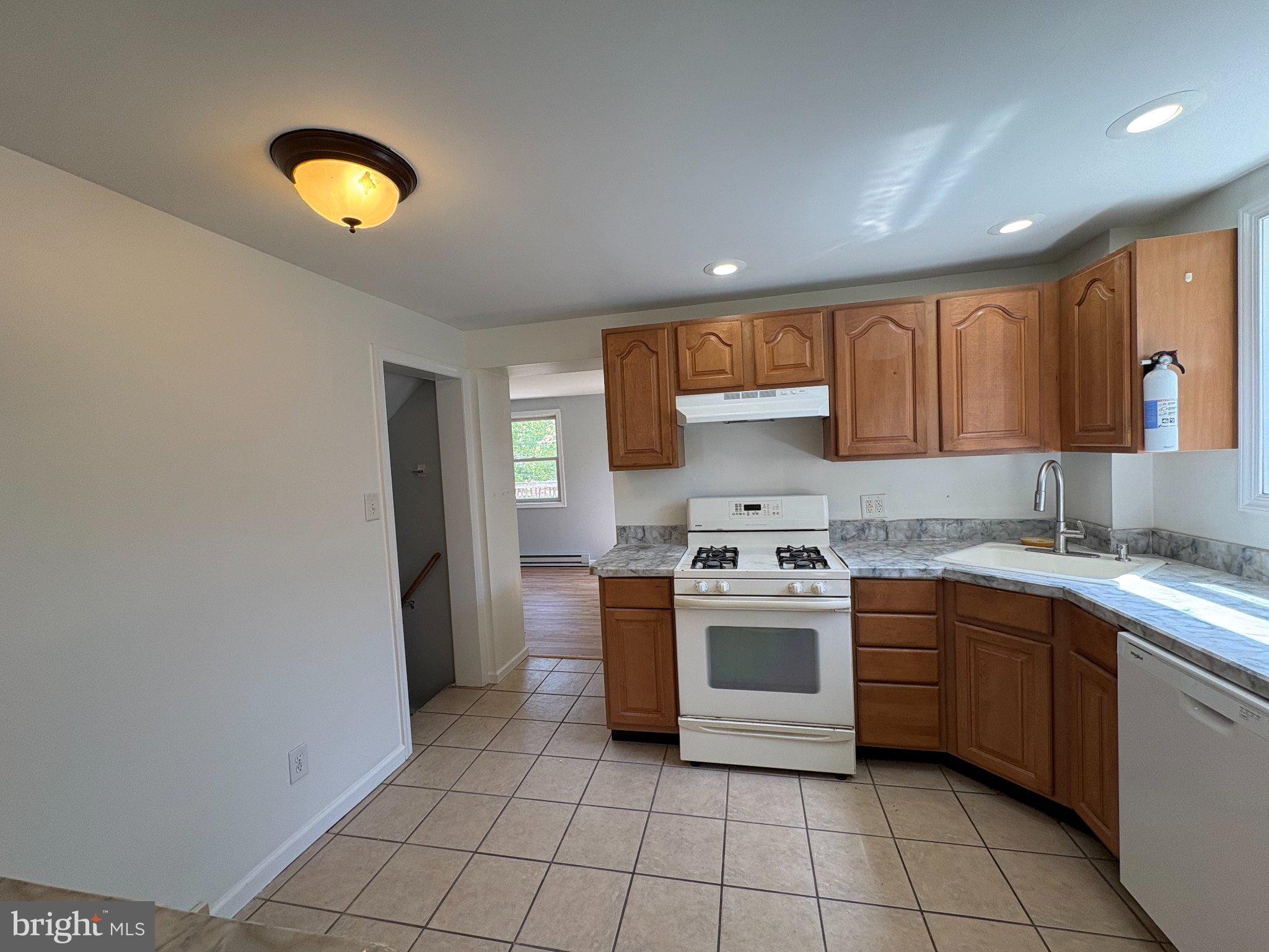 2515 Woodleigh Road Havertown, PA 19083 - Photo 7 of 31 a kitchen with a stove sink and cabinets