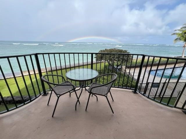 a balcony with table and chairs