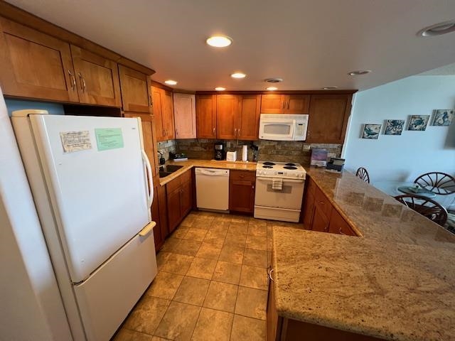 4471 Lower Honoapiilani Road, Unit 202 Lahaina, HI 96761 - Photo 3 of 24 a kitchen with a sink a refrigerator and cabinets