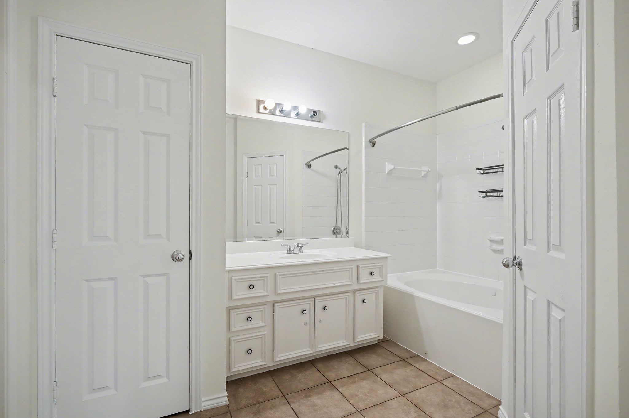 2416 Charleston Street, Unit A Houston, TX 77021 - Photo 20 of 24 a spacious bathroom with a double vanity sink a mirror and a bathtub
