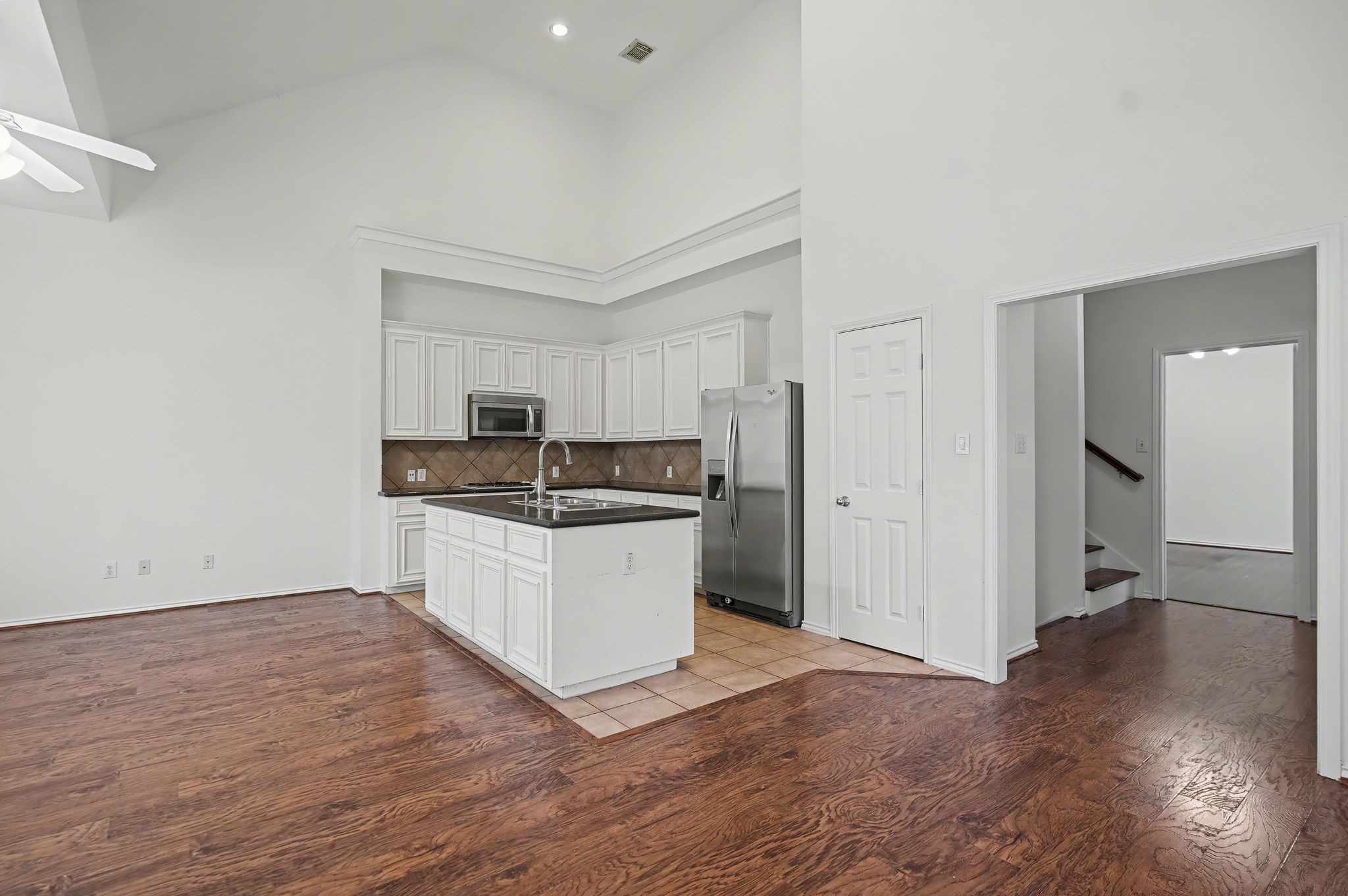 2416 Charleston Street, Unit A Houston, TX 77021 - Photo 5 of 24 a kitchen with a refrigerator and a stove top oven