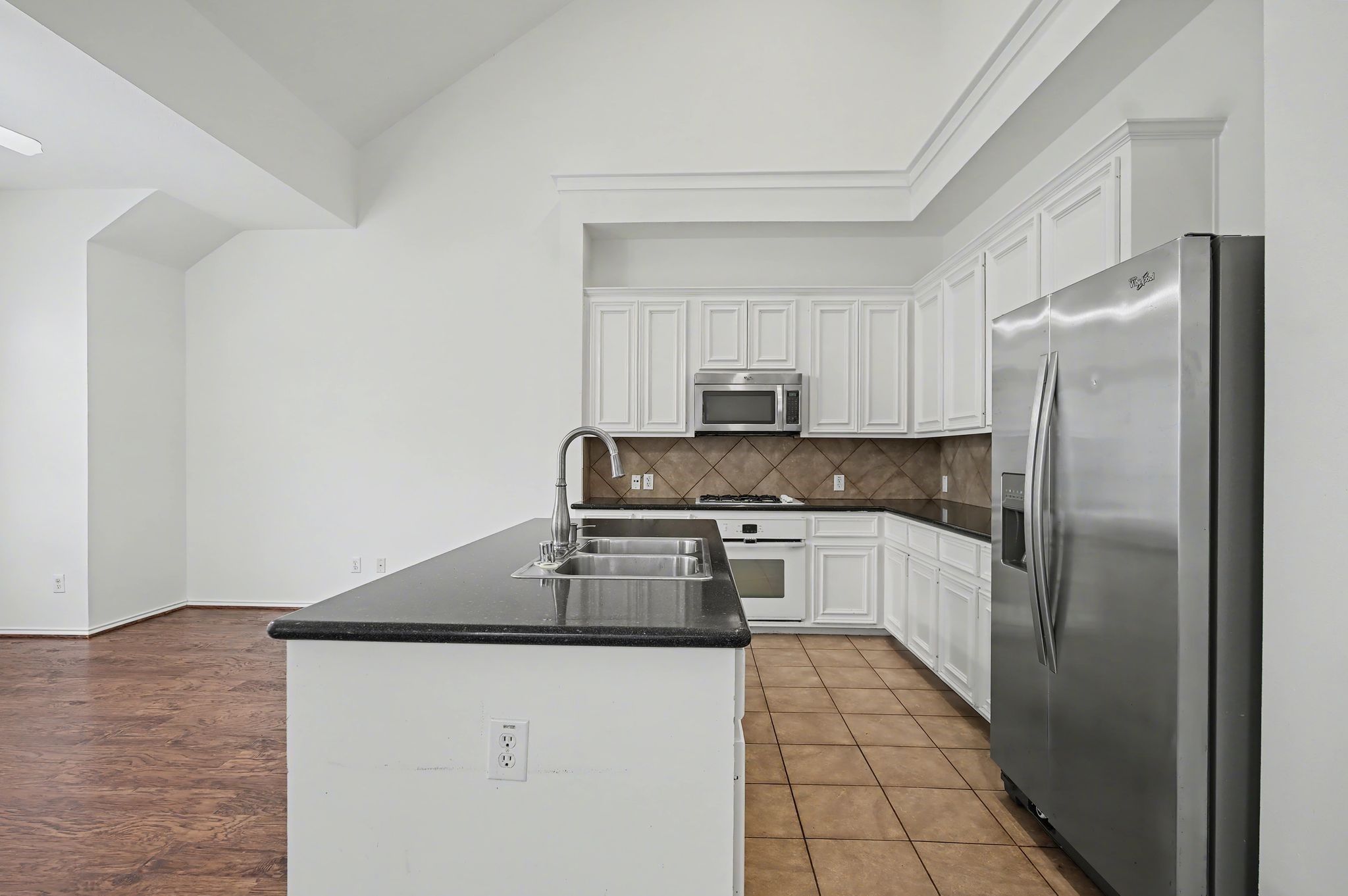 2416 Charleston Street, Unit A Houston, TX 77021 - Photo 10 of 24 a kitchen with stainless steel appliances granite countertop a refrigerator and a stove