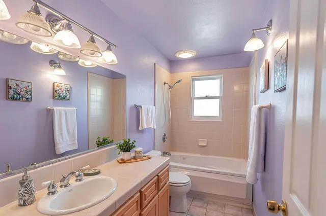 a bathroom with a bathtub a sink and a mirror