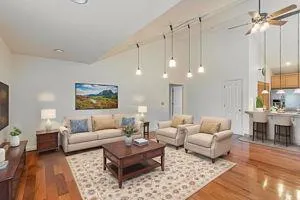 a living room with furniture and a chandelier