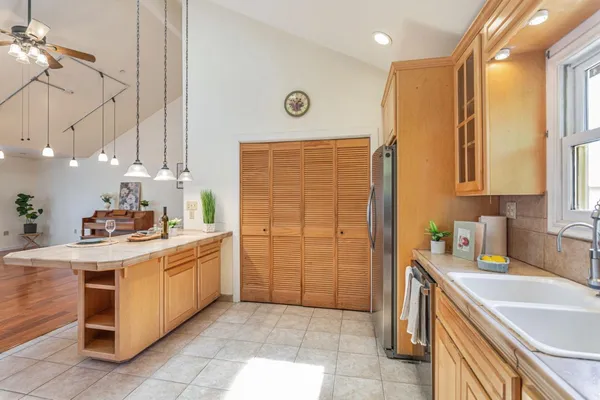 a kitchen with stainless steel appliances granite countertop a sink a stove and a refrigerator