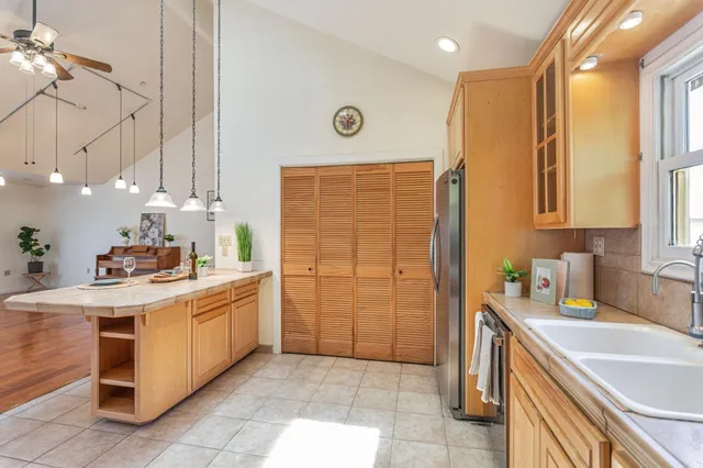 a kitchen with stainless steel appliances granite countertop a sink a stove and a refrigerator