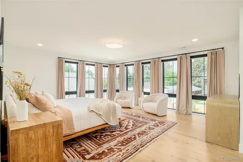 a living room with furniture and large windows