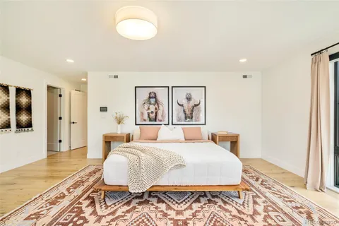 a bedroom with a large bed and a couch