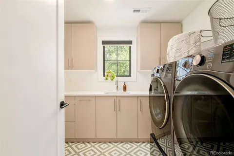 a utility room with a sink a washer and dryer