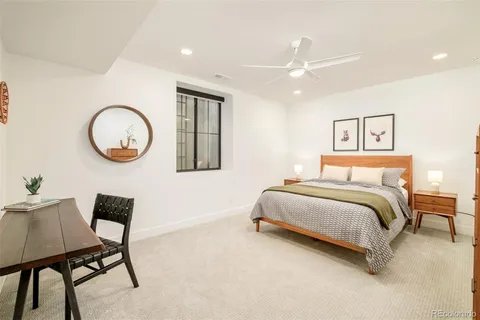 a bedroom with a bed and a lamp with the dresser