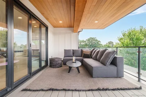 a living room with furniture and a floor to ceiling window