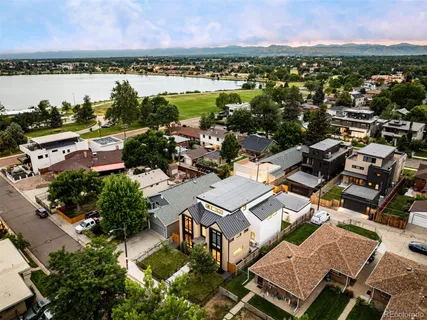 an aerial view of a city with lots of residential buildings and ocean view in back