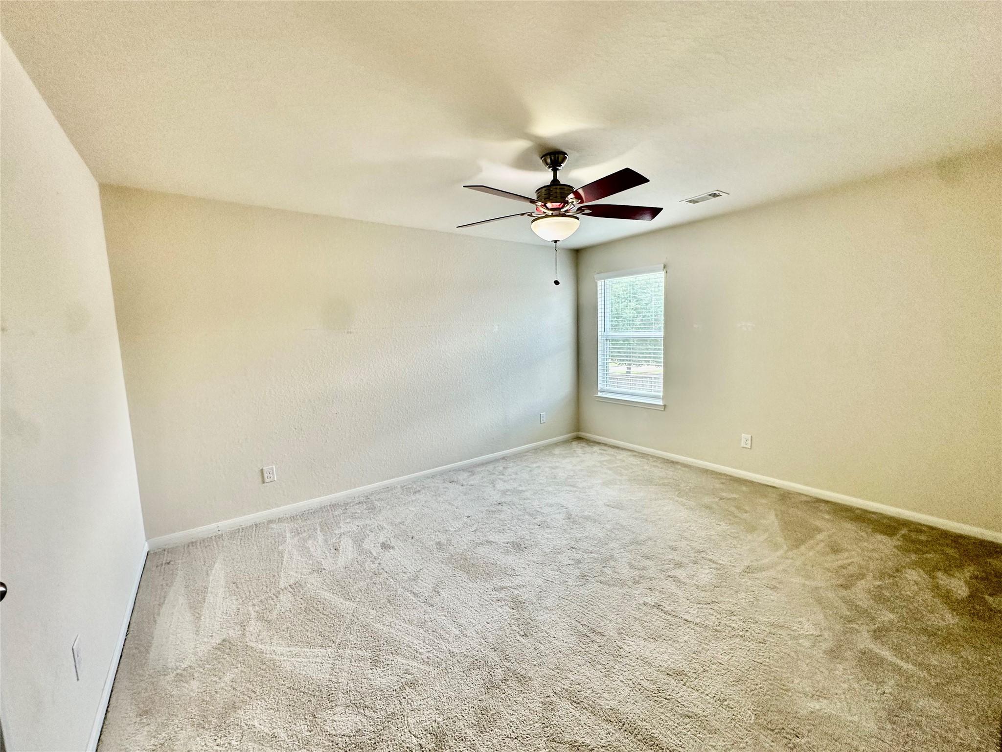 18622 Each Elm Way Houston, TX 77084 - Photo 31 of 35 an empty room with a chandelier fan and windows