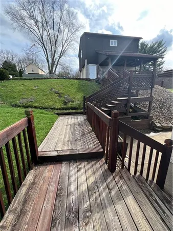 a view of a backyard with a deck and a patio